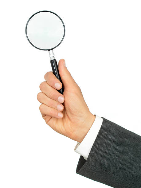 istock Businessman's Hands Holding Magnifying Glass 115865701