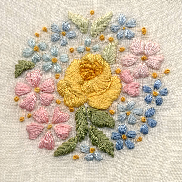 hand-embroidered flower motif Antique hand embroidery. Satin stitch and French knots. Cotton on cotton. Original motif 2 1/4" diameter. thread sewing item stock pictures, royalty-free photos & images