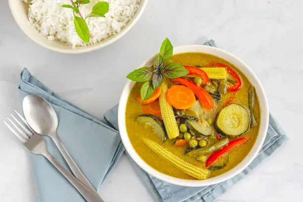 Vegan Thai Green Curry with Rice, Garnished with Thai Basil, Directly Above Photo. Traditional Thai Food Photography"n