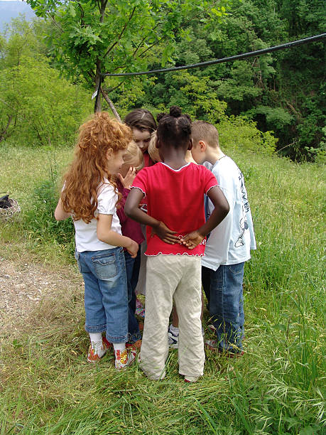 istock Group of children playing outside together 115866578