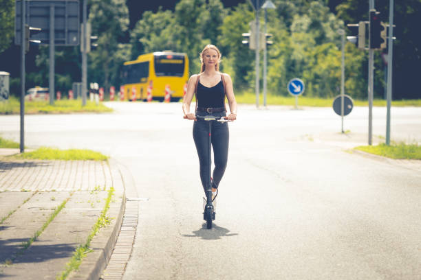 istock Young woman with electric scooter 1158668378