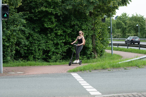 istock Young woman with electric scooter 1158668674