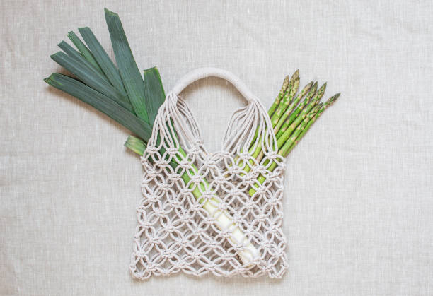 Handmade macrame shopping bags on the linen background, ECO friendly. Embroidery. Modern summer concept