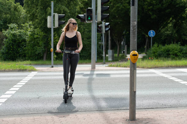 istock Young woman with electric scooter / e-scooter 1158669379