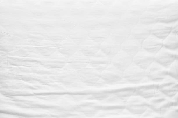 istock Top view Bedding sheets white fabric wrinkled canvas texture background for design blackdrop or overlay background 1158670148