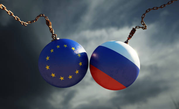 Wrecking balls textured with European Union and Russian flags over dark stormy sky. Horizontal composition with copy space and selective focus. Dispute concept.