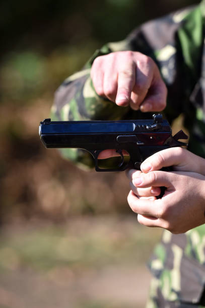istock Outdoor target shooting with a 9mm pistol in a shooting range 1158673949