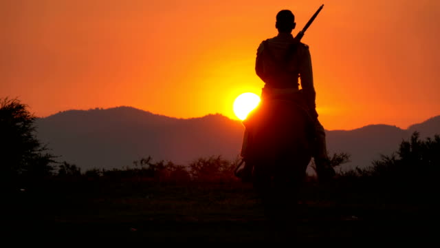 4K Soldier And Cowboy Riding Horses Walking Into The Sunset
