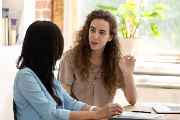 istock Female worker talk discussing idea in office with colleague 1158676616