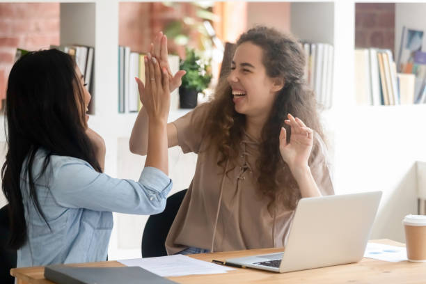 istock Excited millennial colleagues give high five motivated with success 1158676618