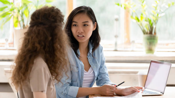istock Young Asian worker talk discussing paperwork with colleague 1158676638