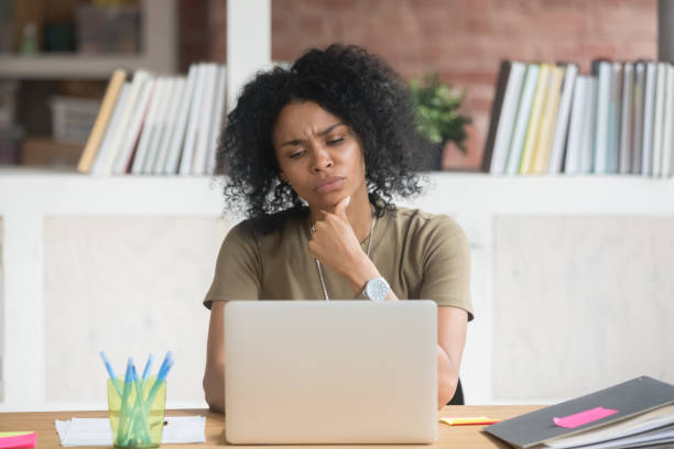 istock Pensive black woman work at laptop thinking making decision 1158676690