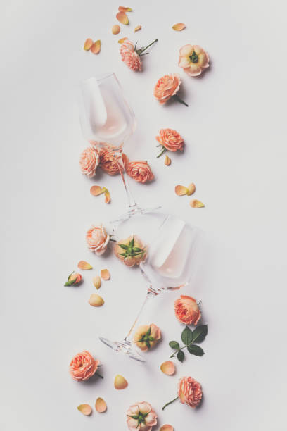 istock Rose wine and roses on white background 1158679625