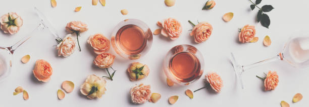 istock Rose wine and roses on white background 1158679631