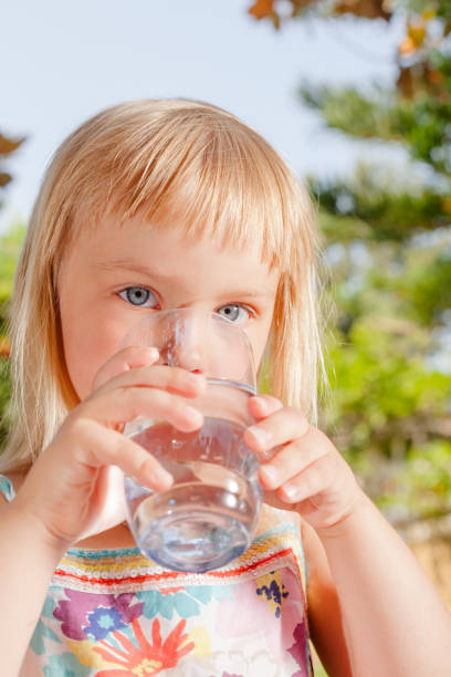 istock Child drinking water outdoors 1158680317