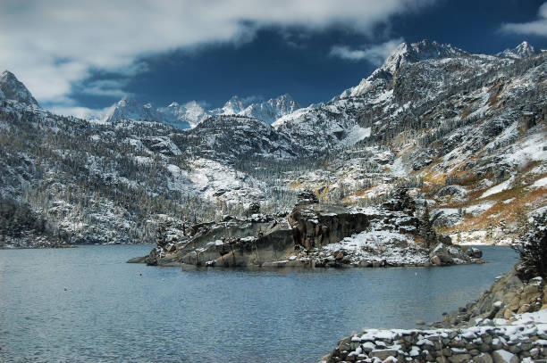 istock Moody Scene with Lake, Snow Capped Mountains and Sky 1158680679