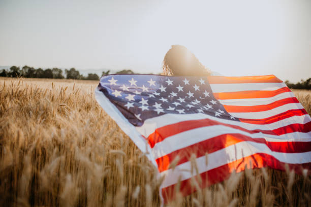 istock Young pretty woman walks in the cornfield while enjoying sunset 1158680885