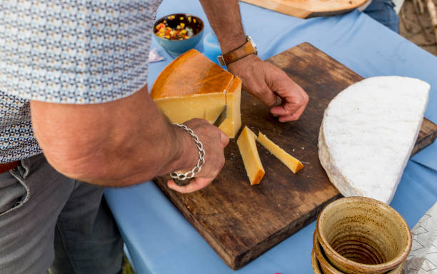 istock man cutting old cheese in holland 1158681914