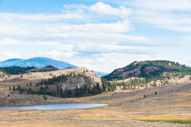 istock Small lake surrounded by natural grasslands and mountains 1158683839