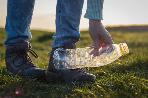 istock Volunteer cleaning plastic waste in nature. Environmental conservation concept. 1158684052