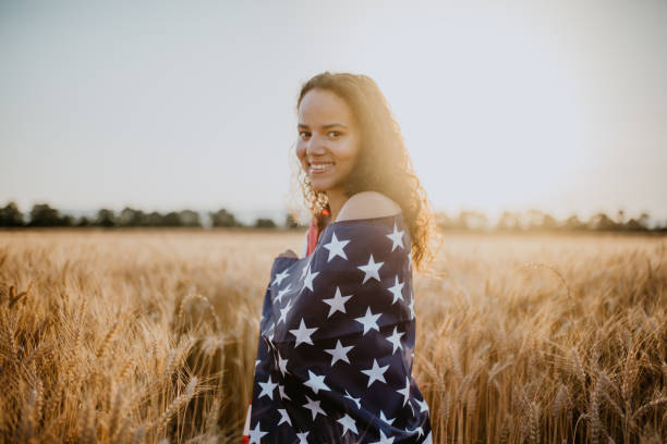 istock Young pretty woman walks in the cornfield while enjoying sunset 1158684086