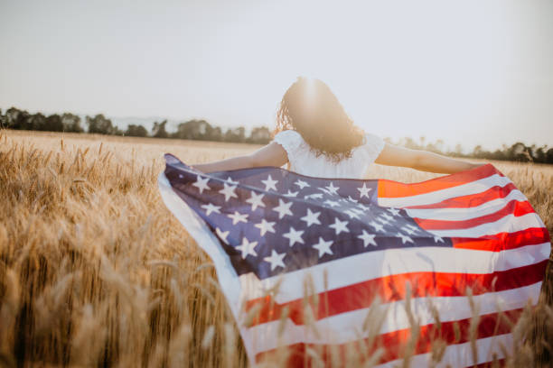 istock Young pretty woman walks in the cornfield while enjoying sunset 1158684905