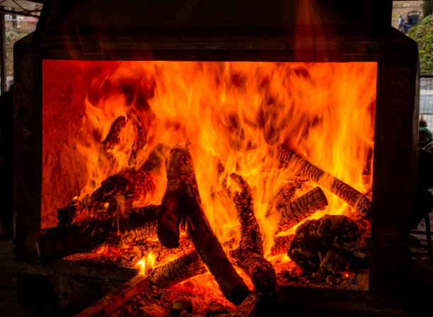 istock Charred wood and bright flames on dark background 1158685174
