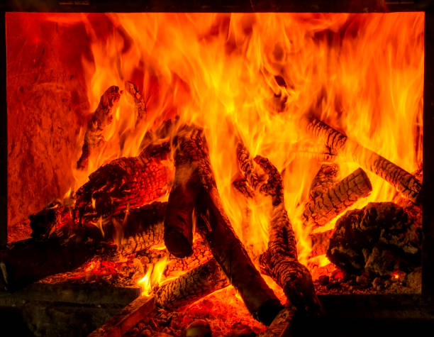istock Charred wood and bright flames on dark background 1158685323
