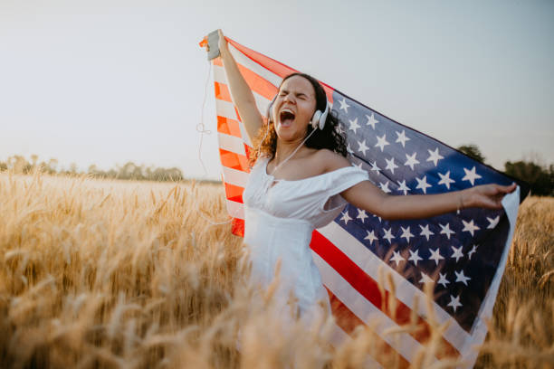 istock Young pretty woman walks in the cornfield while enjoying sunset 1158685387
