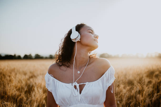 istock Young pretty woman walks in the cornfield while enjoying sunset 1158685500