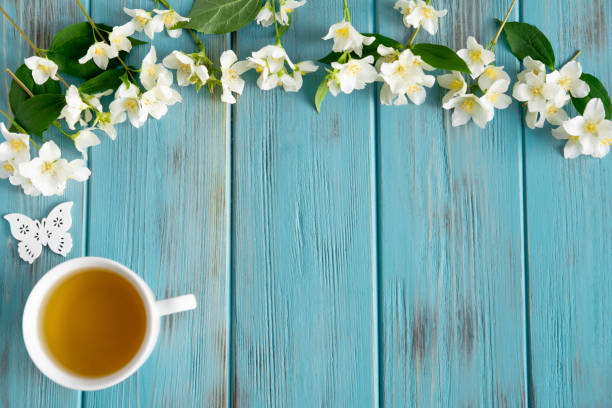 istock Jasmine tea on a blue wooden background. Relaxing jasmine tea. Aromatic teas for relaxation and health. Place for inscription 1158685532