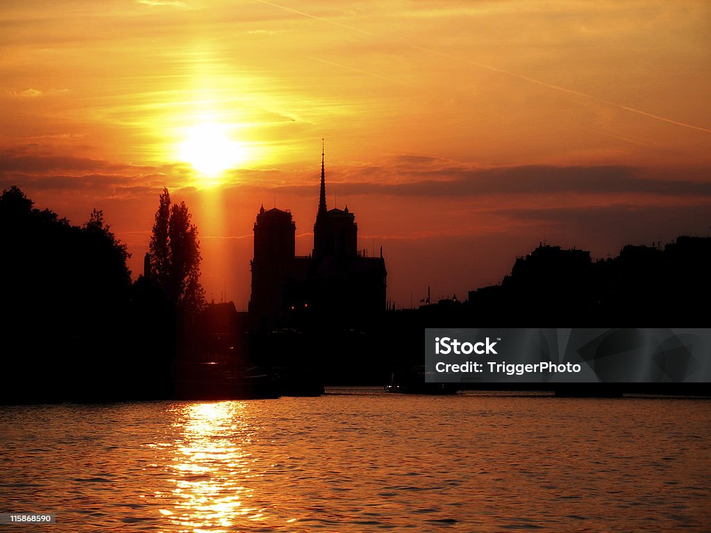 His River Notre Dame sunset stunning sun set on Seine River in Paris, France taken from boat. Notre Dame cathedral in silhouette. landscape version Abstract Stock Photo