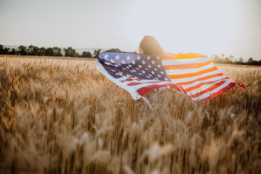 Young Pretty Woman Enjoys Sunset in Cornfield