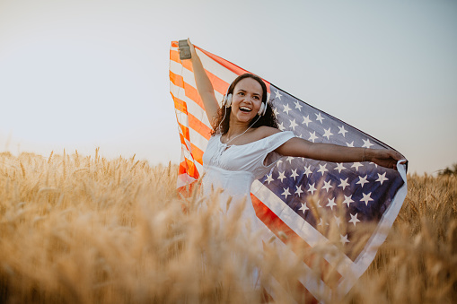 Young Pretty Woman Enjoys Sunset in Cornfield