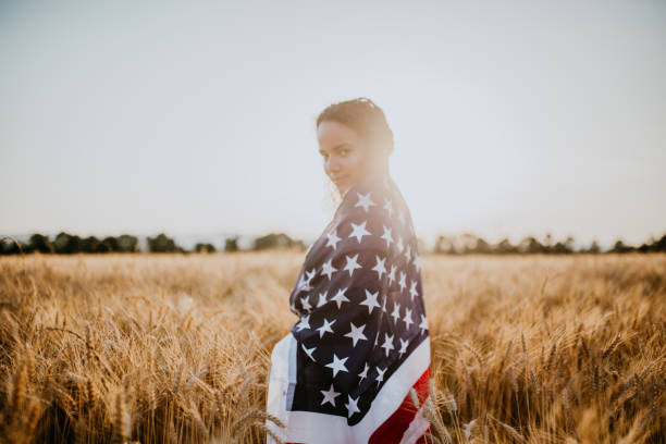 istock Young pretty woman walks in the cornfield while enjoying sunset 1158686624