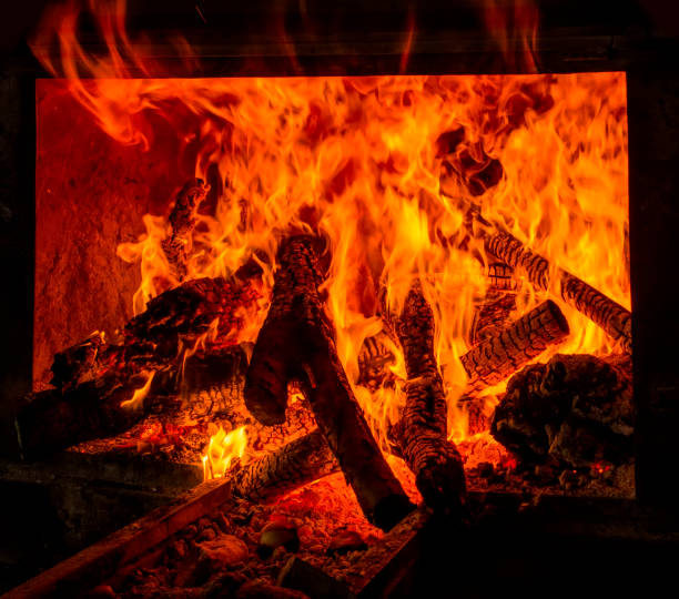 istock Charred wood and bright flames on dark background 1158686646