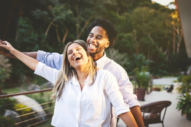 istock Young couple embracing and having fun outdoors 1158686903