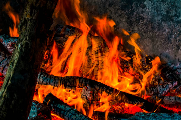 istock Charred wood and bright flames on dark background 1158688082