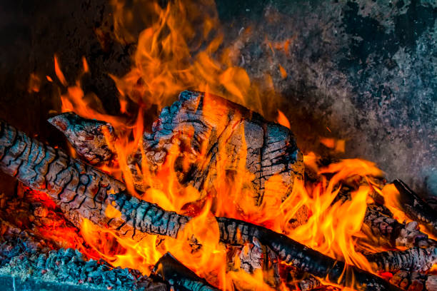 istock Charred wood and bright flames on dark background 1158688710