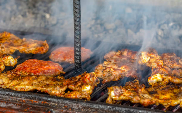 istock Tasty chicken meat on the grill with fire flames 1158690048
