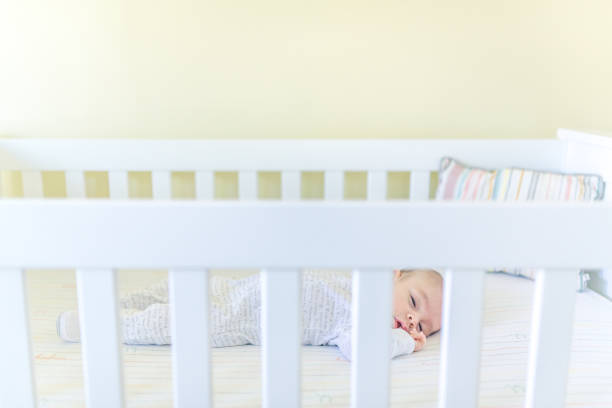 istock Sweet baby sleeping in a crib 1158691339