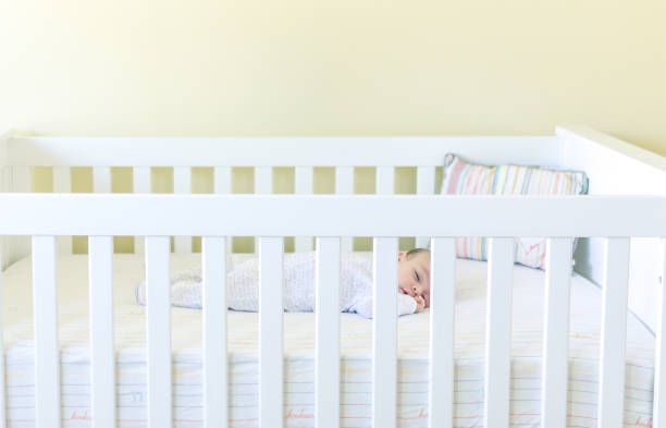 istock Sweet baby sleeping in a crib 1158691379