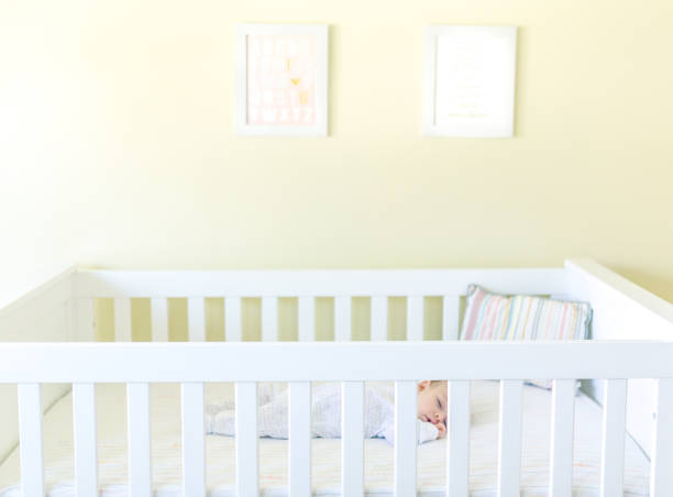 istock Sweet baby sleeping in a crib 1158691531