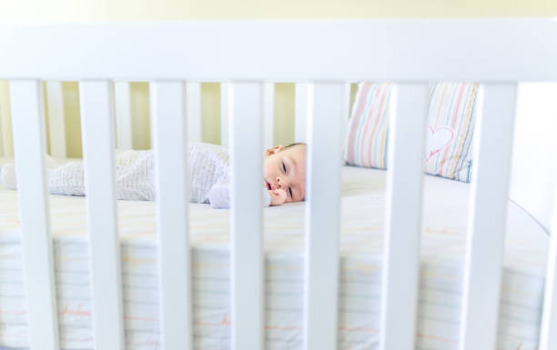 istock Sweet baby sleeping in a crib 1158691693