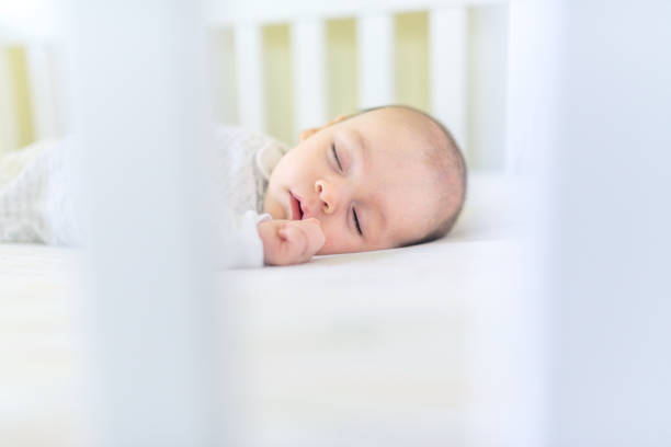 istock Sweet baby sleeping in a crib 1158691736