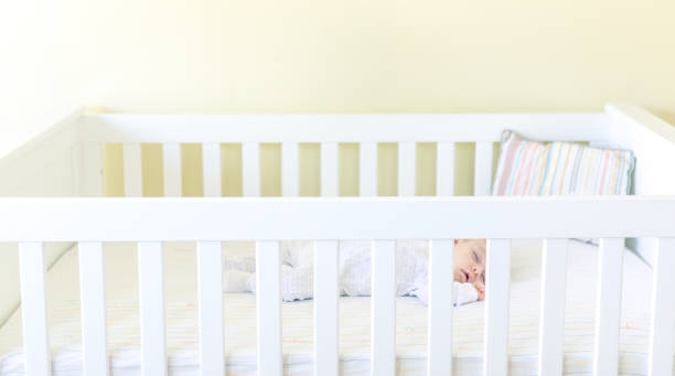 istock Sweet baby sleeping in a crib 1158692348