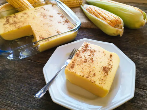 Photo of Canjica typical brazilian junina party sweet - Corn cobs on wooden background