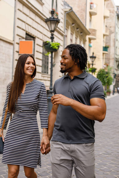 istock Couple walking down the city street 1158693721