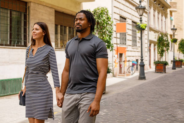 istock Couple walking down the city street 1158693849