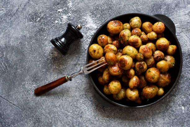 istock Fried, young potatoes with spices in a pan. View from above. 1158694053